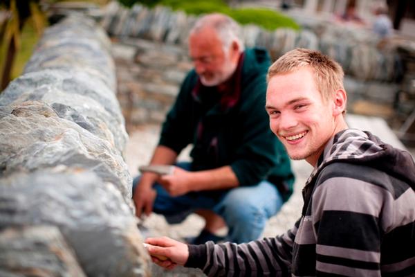 Alexander Pedley (foreground), Redvers Parsons (background) work on the cemetery wall at Clyde (picture by: Isabella Harrex)